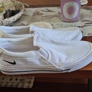 Nike White Canvas Slip-On Sneakers with Black Swoosh Accent